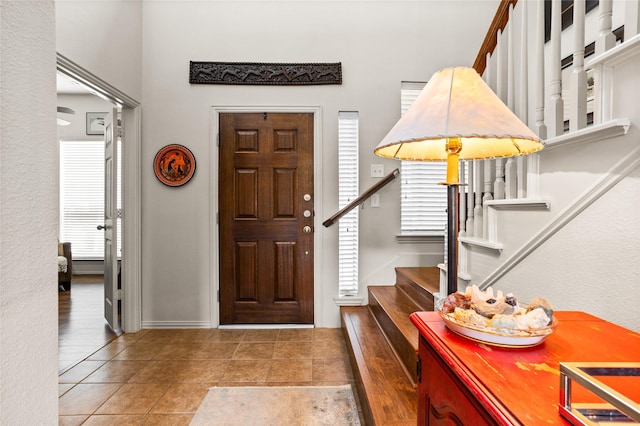 foyer entrance featuring stairs and tile patterned floors