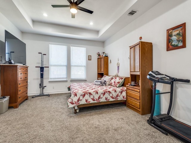 bedroom with recessed lighting, a raised ceiling, visible vents, and light colored carpet