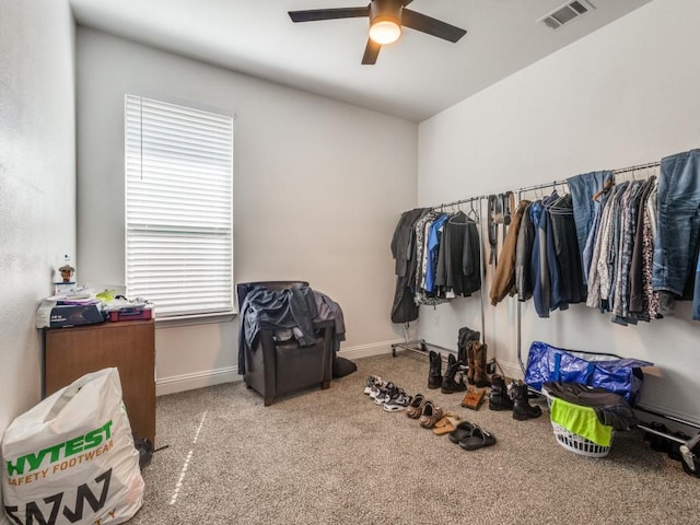 spacious closet with carpet floors, visible vents, and ceiling fan