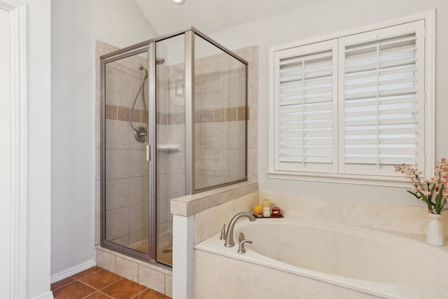 full bathroom with a stall shower, tile patterned flooring, a textured ceiling, and a bath