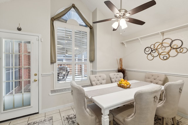 dining space featuring ceiling fan, light tile patterned flooring, and baseboards