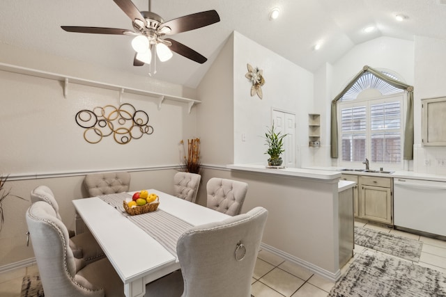 dining space with a ceiling fan, lofted ceiling, and light tile patterned floors