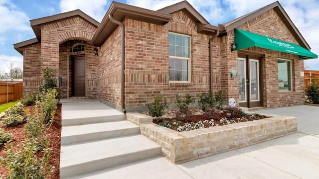 view of front of home with brick siding