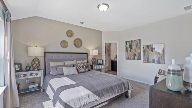 bedroom with ensuite bathroom, carpet floors, visible vents, baseboards, and vaulted ceiling