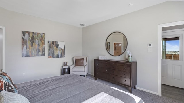 carpeted bedroom featuring visible vents and baseboards