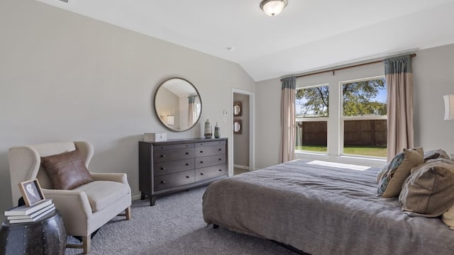 bedroom with lofted ceiling, carpet, and baseboards