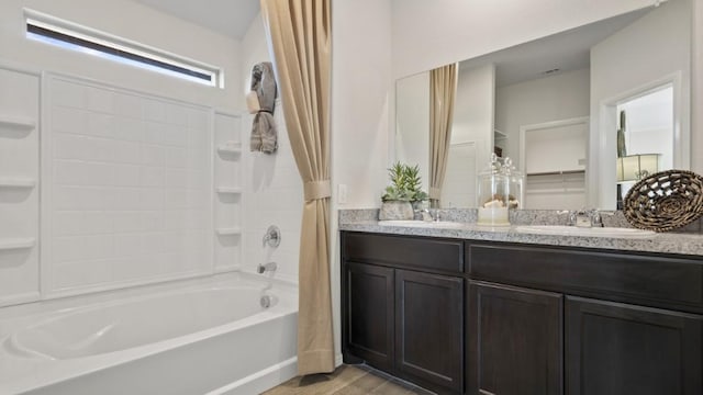 bathroom with double vanity, a sink, and shower / bathtub combination with curtain