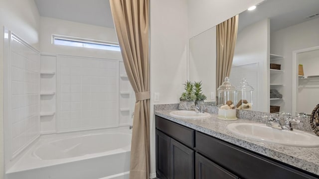 full bath featuring double vanity, shower / bath combo, visible vents, and a sink