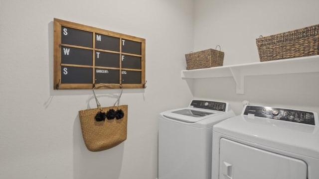 clothes washing area featuring laundry area and washer and dryer