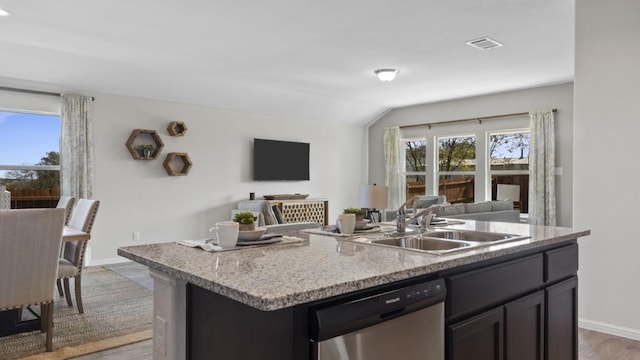 kitchen with a sink, visible vents, open floor plan, a wealth of natural light, and dishwasher