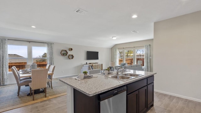 kitchen featuring a sink, visible vents, open floor plan, dishwasher, and plenty of natural light