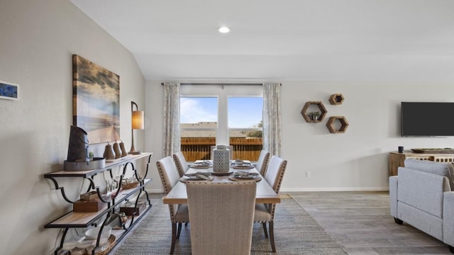 dining space featuring vaulted ceiling, recessed lighting, wood finished floors, and baseboards