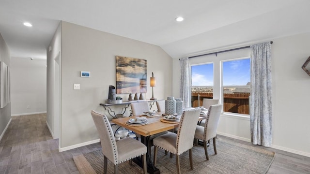 dining room featuring lofted ceiling, recessed lighting, wood finished floors, and baseboards