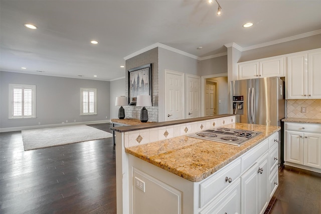 kitchen with baseboards, appliances with stainless steel finishes, ornamental molding, tasteful backsplash, and dark wood finished floors