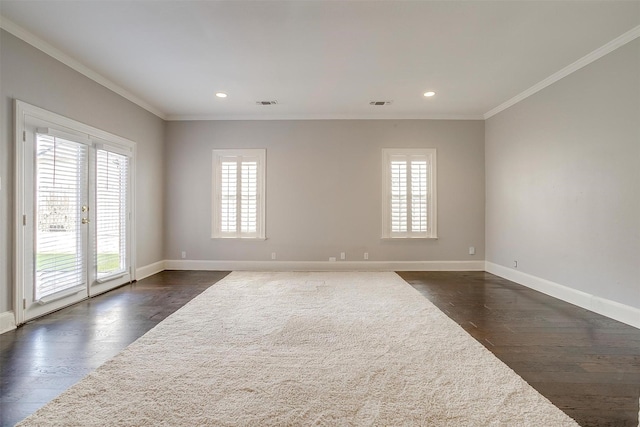 unfurnished room featuring baseboards, ornamental molding, dark wood-type flooring, and a wealth of natural light