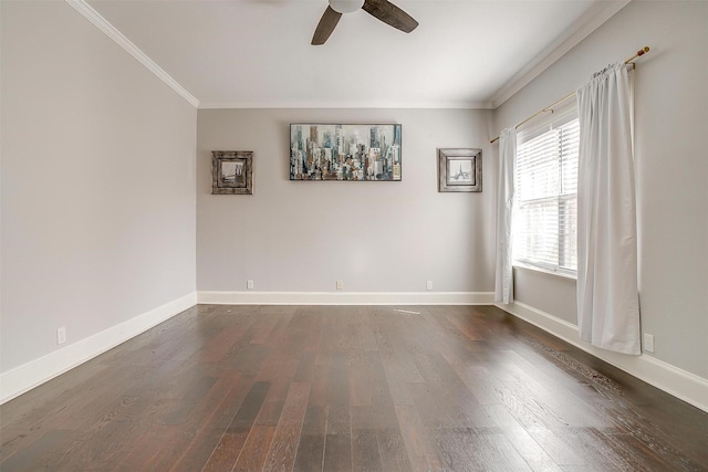 empty room featuring baseboards, ceiling fan, dark wood-type flooring, and crown molding