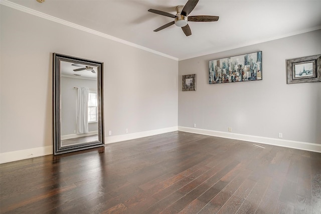 empty room with dark wood-style floors, baseboards, and crown molding