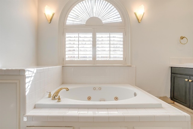 bathroom with a whirlpool tub and vanity