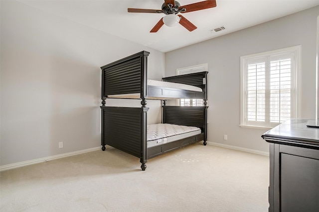 unfurnished bedroom with light colored carpet, visible vents, ceiling fan, and baseboards