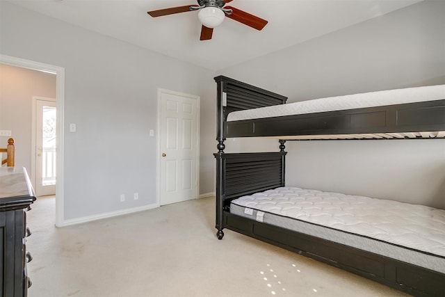 bedroom with baseboards, ceiling fan, and light colored carpet