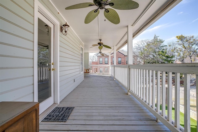 deck featuring covered porch and a ceiling fan