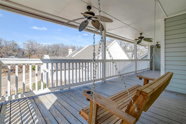 wooden deck featuring ceiling fan