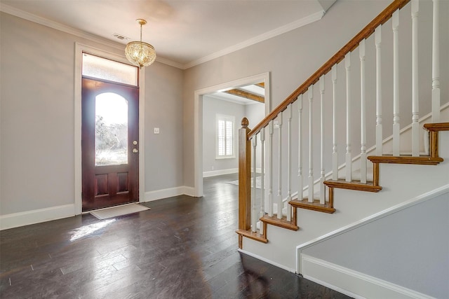 foyer featuring visible vents, baseboards, stairway, dark wood finished floors, and crown molding