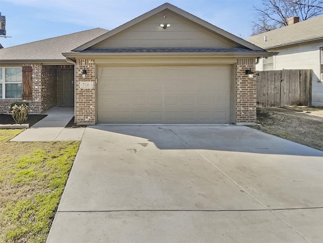 ranch-style house featuring concrete driveway, roof with shingles, an attached garage, fence, and brick siding