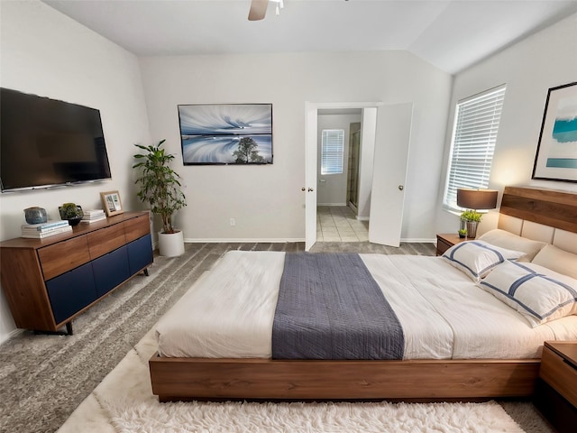 bedroom featuring a ceiling fan, lofted ceiling, and baseboards