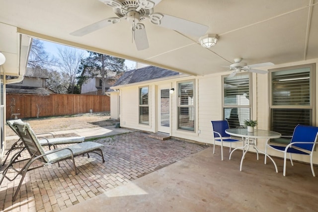 view of patio / terrace with fence, a ceiling fan, and outdoor dining space