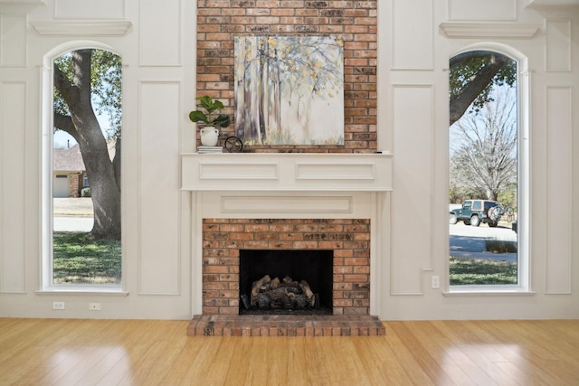 room details featuring a brick fireplace and wood finished floors