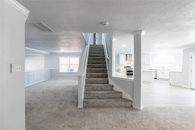 6512 Willow Oak Ct, Fort Worth, TX 76112 - stairs with crown molding, baseboards, carpet, and a textured ceiling