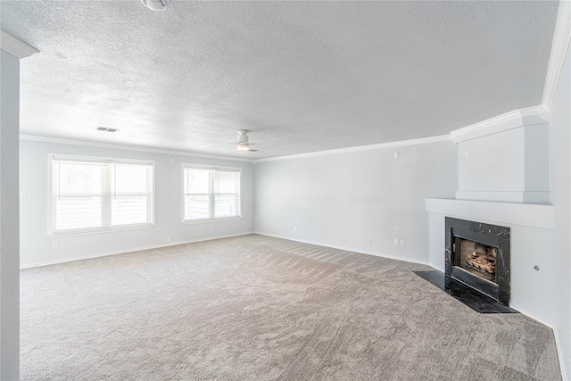 unfurnished living room with carpet, crown molding, a ceiling fan, a high end fireplace, and baseboards