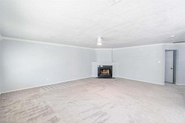 unfurnished living room with carpet, a fireplace with flush hearth, and ornamental molding