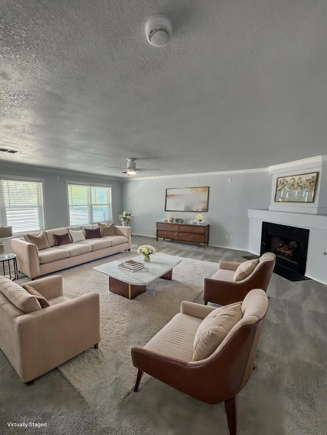 6512 Willow Oak Ct, Fort Worth, TX 76112 - carpeted living area with a fireplace with flush hearth, ceiling fan, a textured ceiling, and visible vents