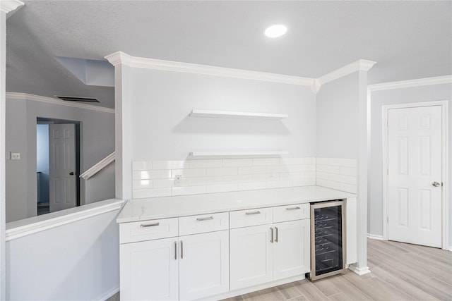 kitchen featuring wine cooler, visible vents, white cabinets, light wood-type flooring, and open shelves