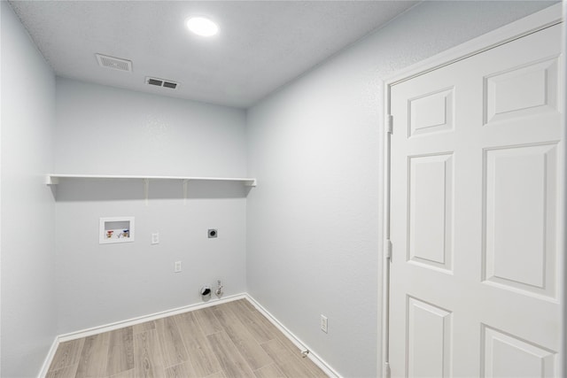 clothes washing area featuring hookup for a washing machine, laundry area, hookup for an electric dryer, and visible vents