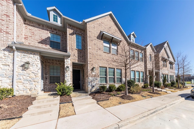 townhome / multi-family property with brick siding