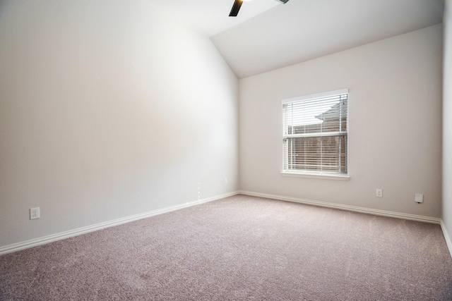 carpeted spare room with a ceiling fan, lofted ceiling, and baseboards