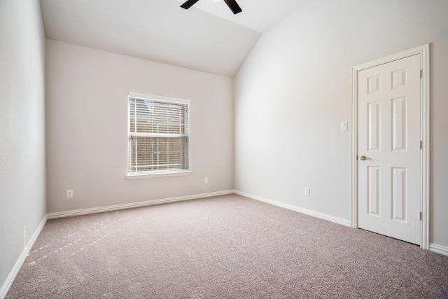 unfurnished room with lofted ceiling, carpet floors, a ceiling fan, and baseboards