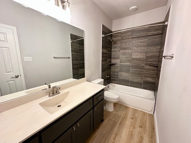 bathroom featuring bathing tub / shower combination, vanity, toilet, and wood finished floors