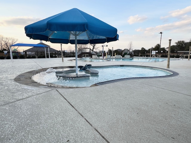 pool with a water slide and fence