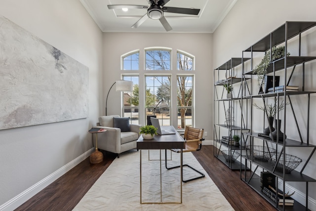 sitting room with baseboards, crown molding, a ceiling fan, and wood finished floors