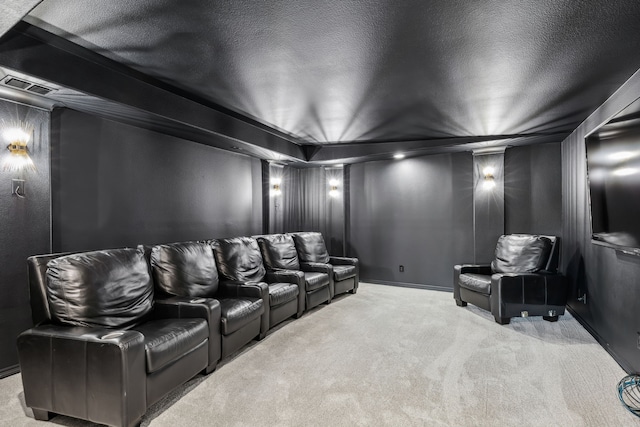 home theater with a textured ceiling and carpet