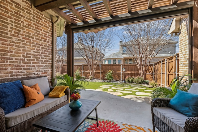 view of patio / terrace featuring a fenced backyard, an outdoor living space, and a pergola