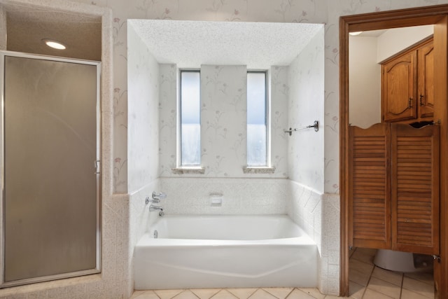 full bath with a stall shower, a garden tub, wallpapered walls, and tile patterned floors