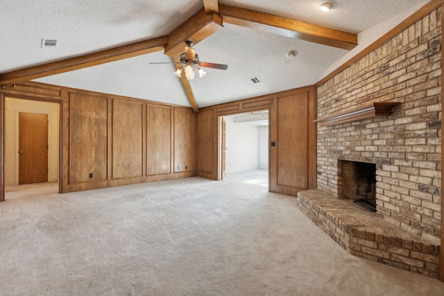 unfurnished living room featuring light carpet, a brick fireplace, visible vents, and a textured ceiling