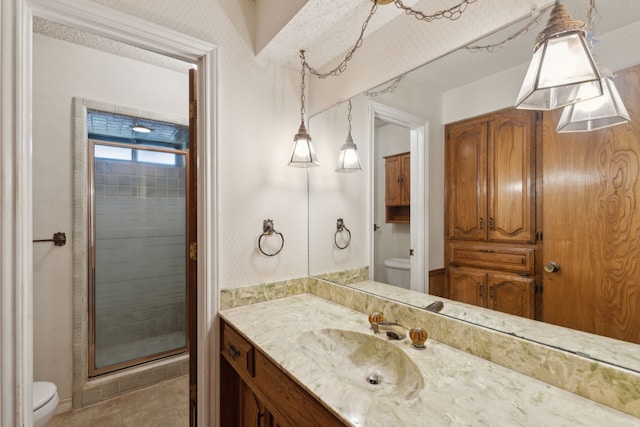 full bathroom with a stall shower, vanity, and toilet