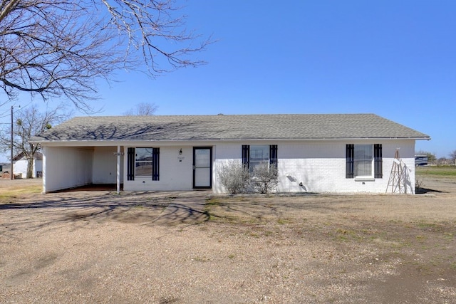 view of front of property featuring brick siding and a shingled roof