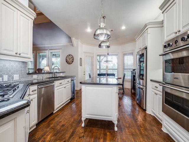 kitchen featuring stainless steel appliances, tasteful backsplash, a sink, and a healthy amount of sunlight